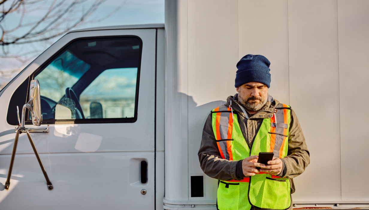 truck driver text messaging on cell phone on parki 2024 12 13 18 34 17 utc