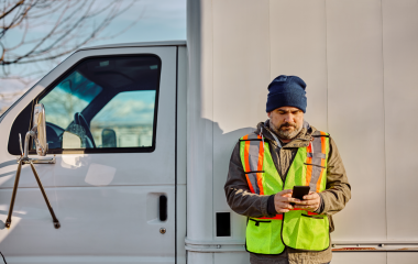 truck driver text messaging on cell phone on parki 2024 12 13 18 34 17 utc